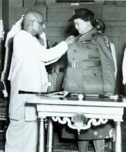 C. Rajagopalachari pinning Florence Nightingale Medal on Mrs. Howard at Government House, New Delhi
