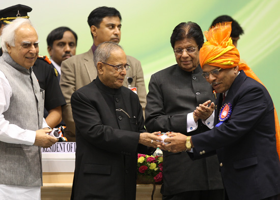 The President of India, Shri Pranab Mukherjee presenting an award to a teacher in New Delhi on September 5, 2012 at the function for the presentation of the National Awards to Teachers. Also seen (from left to right) are the Union Minister of Human Resour