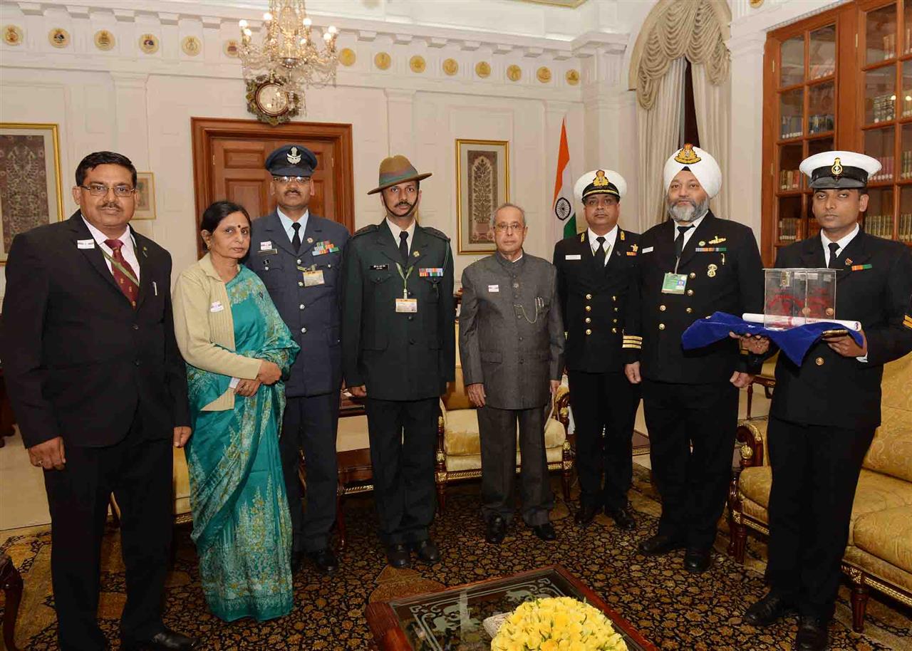 Service Officer and Ladies from the Kendriya Sainik Board, Ministry of Defence pinning a flag on the President of India, Shri Pranab Mukherjee on the occasion of Armed Forces Flag Day at Rashtrapati Bhavan on December 7, 2015.